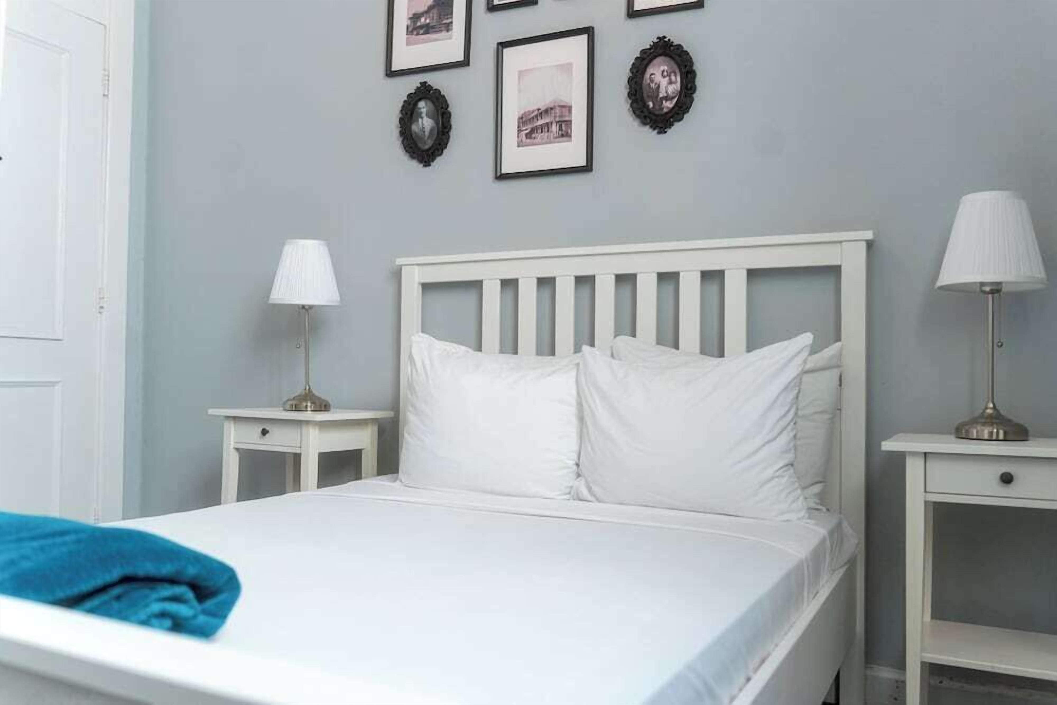 Desk, iron/ironing board, bed sheets