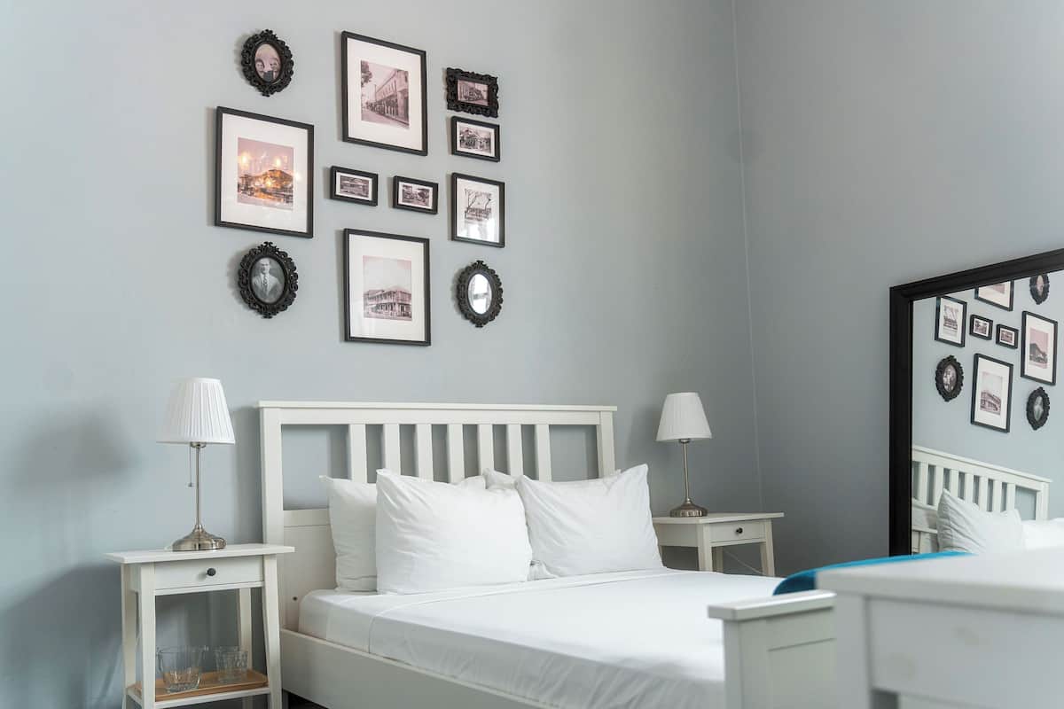 Desk, iron/ironing board, bed sheets