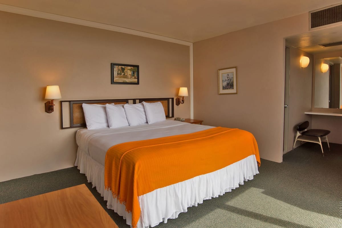 Desk, iron/ironing board, bed sheets