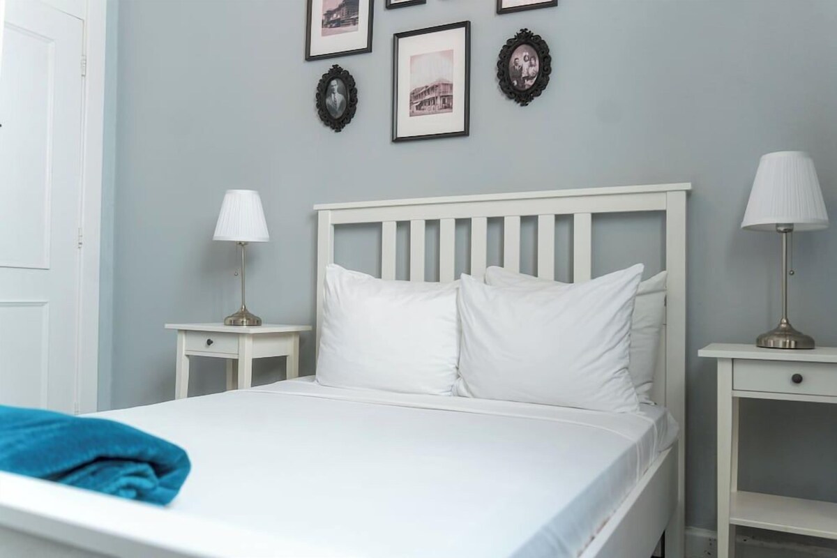 Desk, iron/ironing board, bed sheets