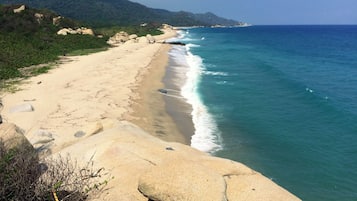 On the beach, white sand, sun loungers