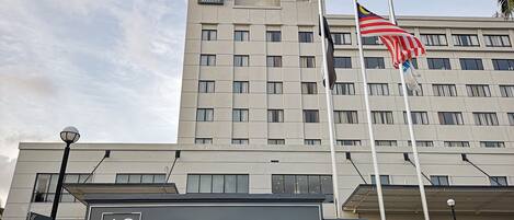 A hotel building with a sign indicating it is an AC Hotel and a Kuantan City Centre Marriott.