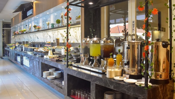 A buffet area with a variety of food items, beverage dispensers, and a push button sign. - Hotel 88 Embong Kenongo by WH (Surabaya)