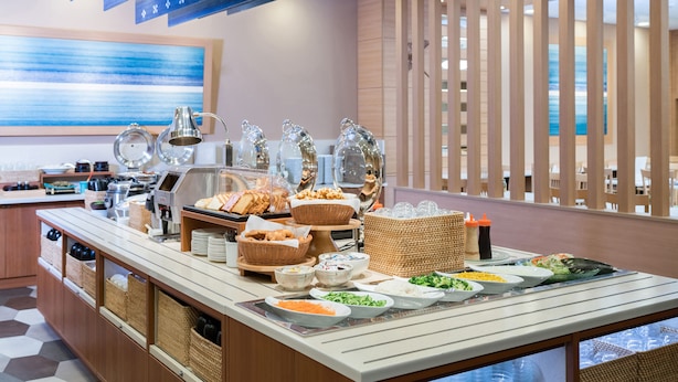 A buffet setup with various food items and beverages.