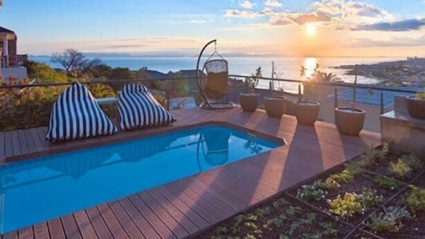 A pool area with a sunset view, lounge chairs, and potted plants. - Fijnbos Private Manor (Cape Town)