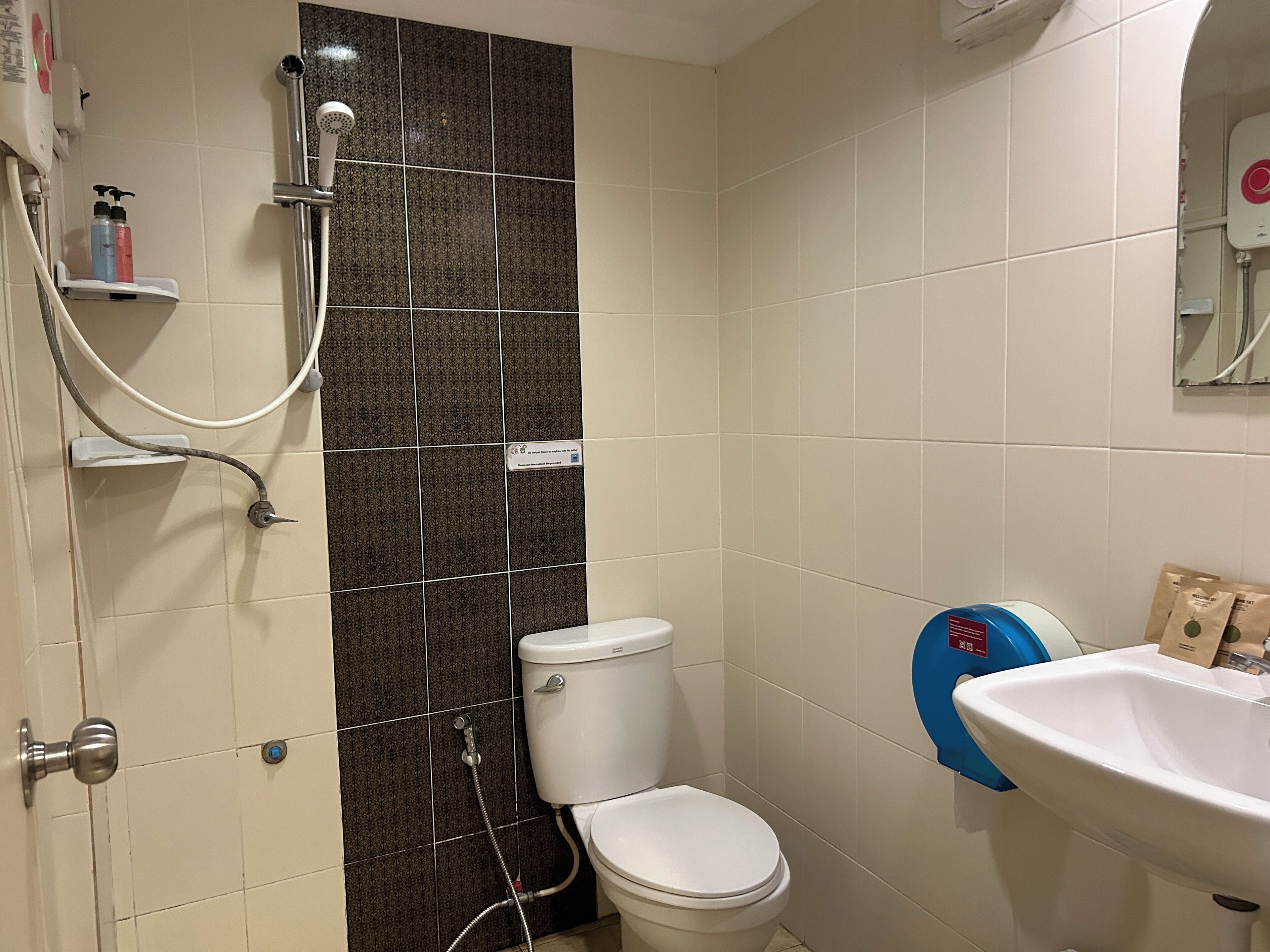 Un baño con inodoro, ducha y lavabo.