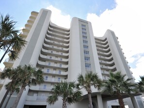 A multi-story hotel with a modern design, featuring balconies on each floor and a prominent 'Tidewater' sign. - Tidewater By Wyndham Vacation Rentals (Orange Beach)