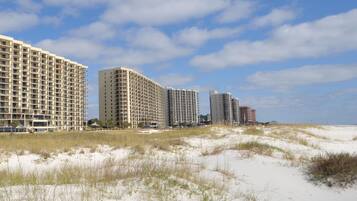 On the beach, white sand, sun loungers, beach umbrellas