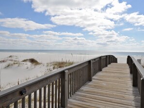 On the beach, white sand, sun loungers, beach umbrellas