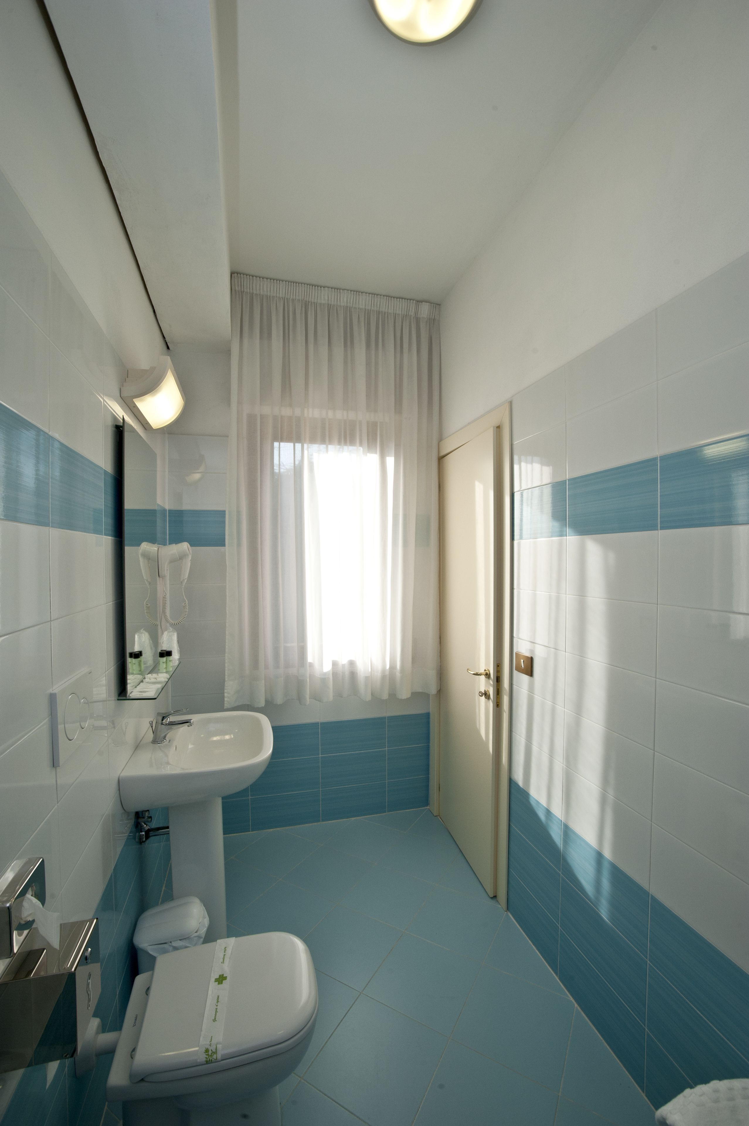 A bathroom with a sink, toilet, and shower.
