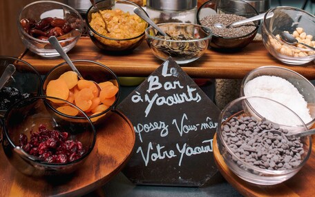 A buffet table with various food items and a chalkboard sign.