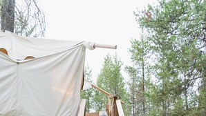 A wooden staircase leading up to a tented structure in a forested area. - Under Canvas Glacier (Coram)