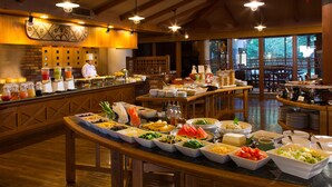 A buffet with various food items and a chef present. - Coco Garden Resort Okinawa (Uruma)