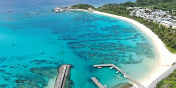 Una playa cerca, sillas reclinables de playa, sombrillas