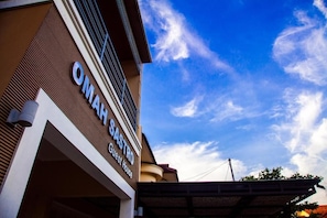 Oman Sastro Guest House features a modern exterior with a prominent sign.