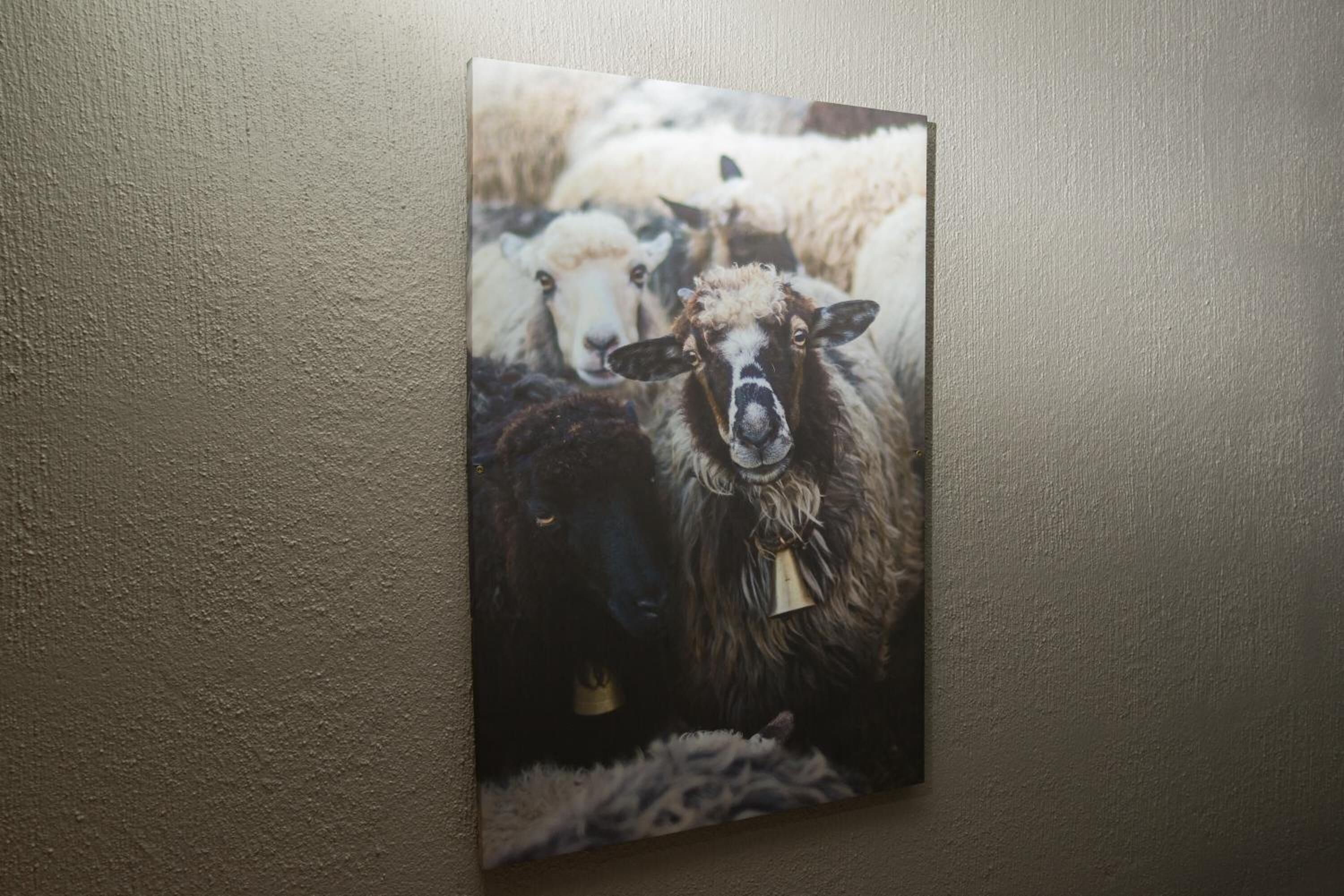 A painting of sheep on a wall.