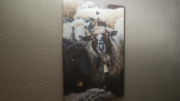 A painting of sheep on a wall.