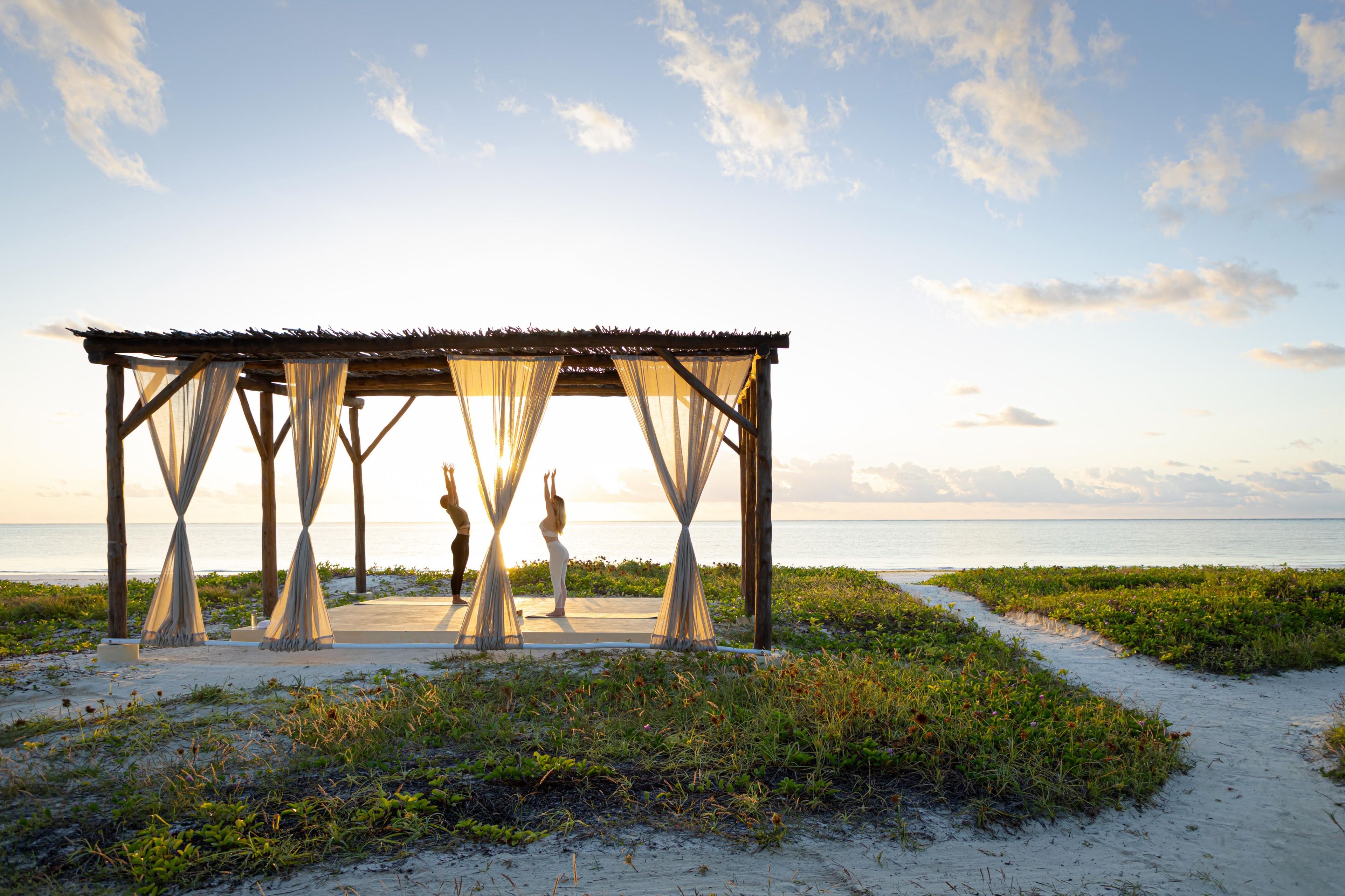 A beachside gazebo with a view of the ocean.