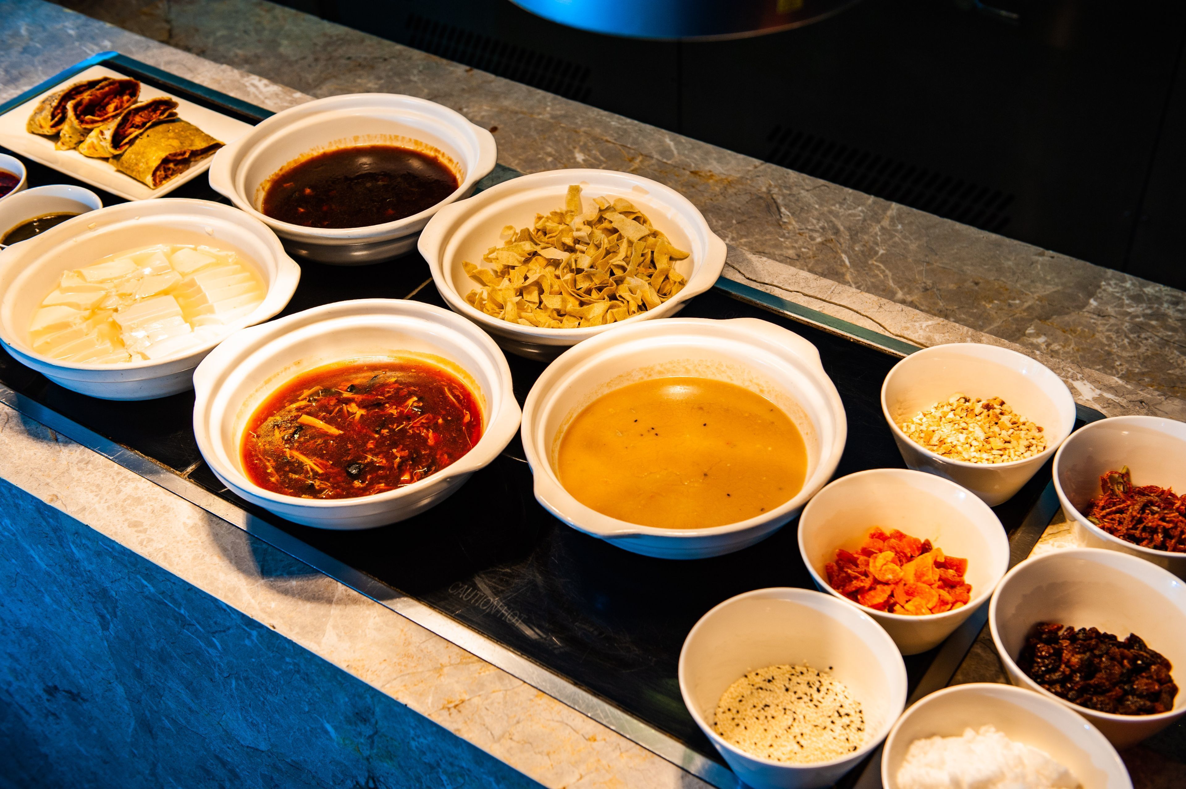 A variety of food items in bowls on a table.