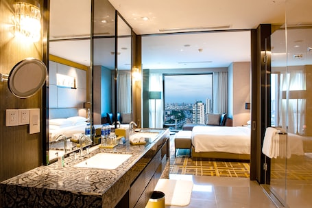Regency, Suite, 1 King Bed | Bathroom | Combined shower/tub, rainfall showerhead, hair dryer, bathrobes