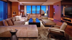A spacious living room with a large sofa set, a coffee table, and a TV. - Hyatt Regency Tianjin East (Tianjin)