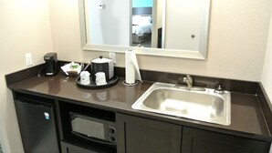 A hotel bathroom with a sink, mirror, coffee maker, and a small refrigerator. - Hampton Inn Carrizo Springs (Carrizo Springs)