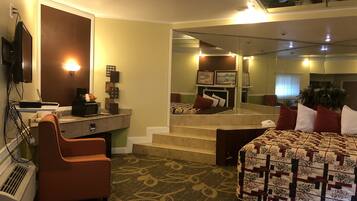 Honeymoon Suite, 1 King Bed, Smoking, Jetted Tub | Living area | 55-inch LED TV with satellite channels, TV, fireplace