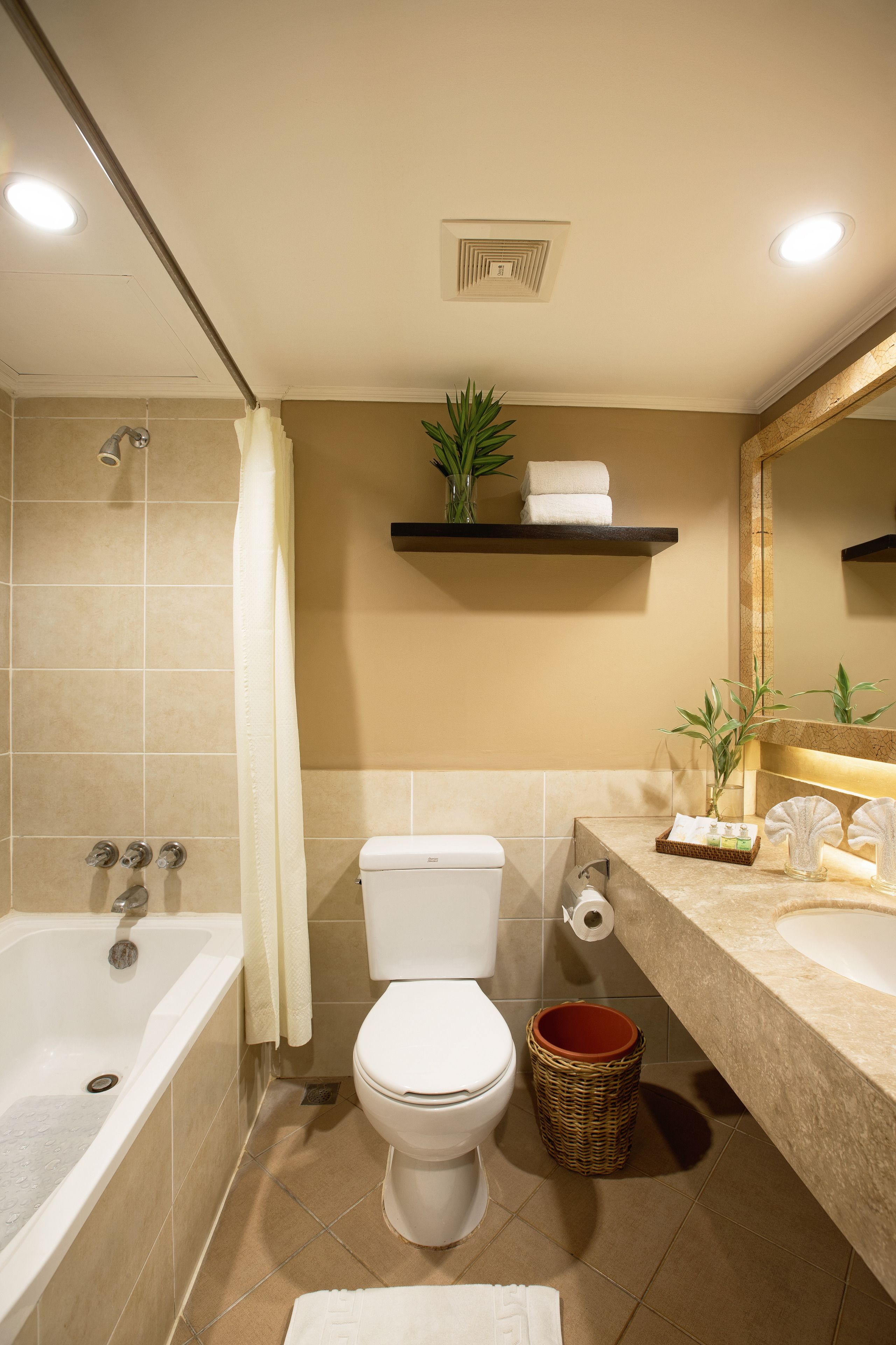 A modern bathroom with a bathtub, toilet, and sink.