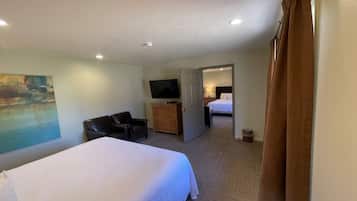 A hotel room with a bed, a television, a desk, and a chair.