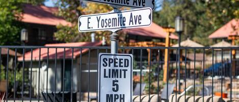 Street signs for E. Yosemite Ave and a speed limit sign of 5 MPH.