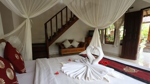 Un dormitorio con una cama, un banco de madera y una escalera.