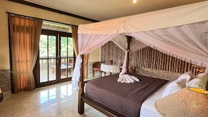 A spacious bedroom with a large bed, a canopy, and a view of the outdoors. - Pande Permai Bungalows (Ubud)
