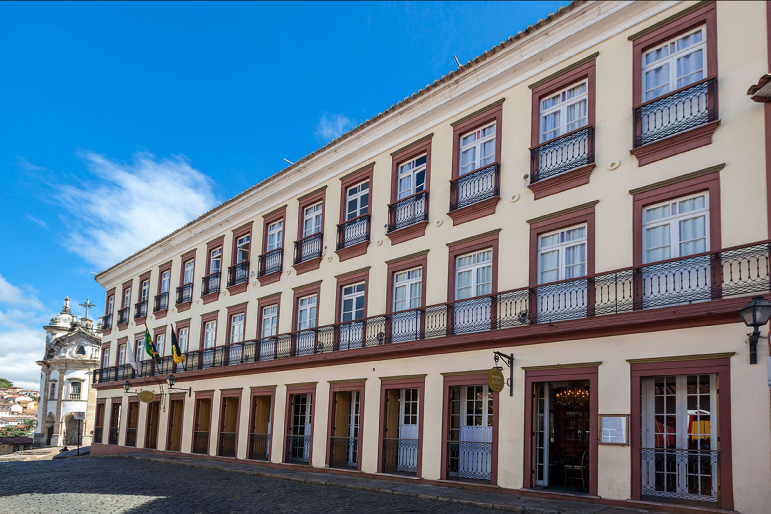 A historic building with multiple balconies and a central entrance.