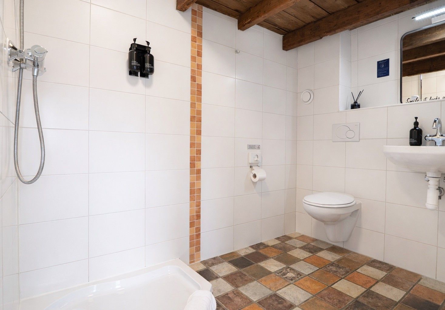 A bathroom with a shower, toilet, and sink.