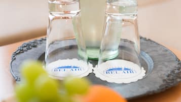 Two glass salt and pepper shakers with 'BEL AIR' labels on a slate tray.