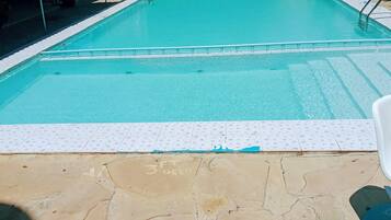 Outdoor pool, open 6 AM to 6 PM, pool umbrellas, pool loungers