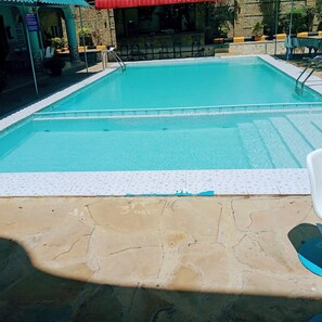 Outdoor pool, open 6 AM to 6 PM, pool umbrellas, pool loungers