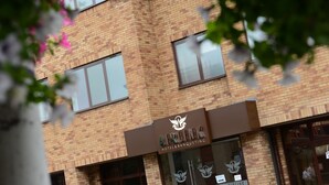 A brick building with a sign for Airlink Hotel & Banqueting.