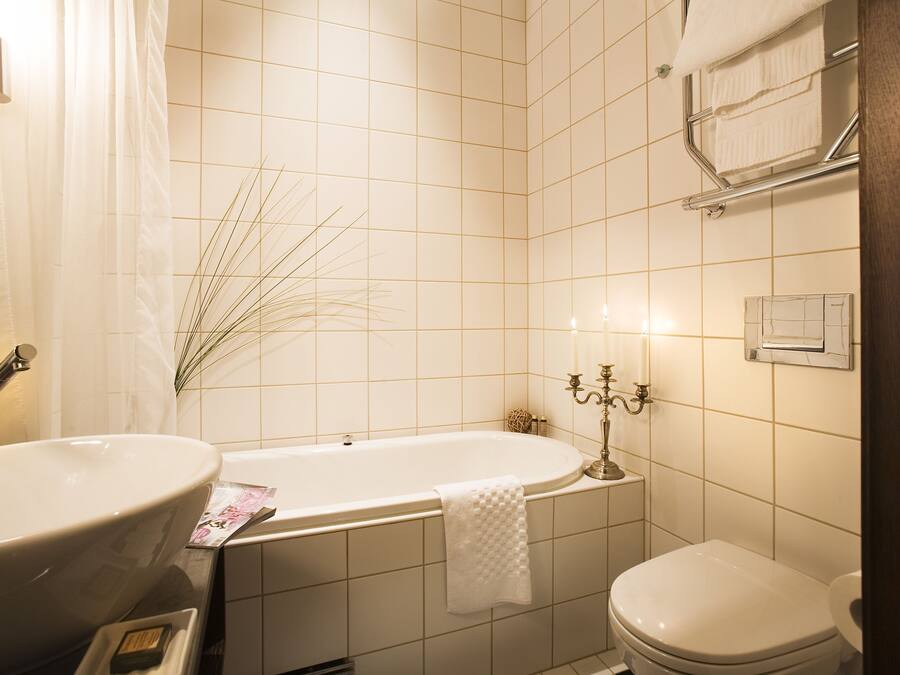 A bathroom with a freestanding bathtub, a sink, and a toilet.