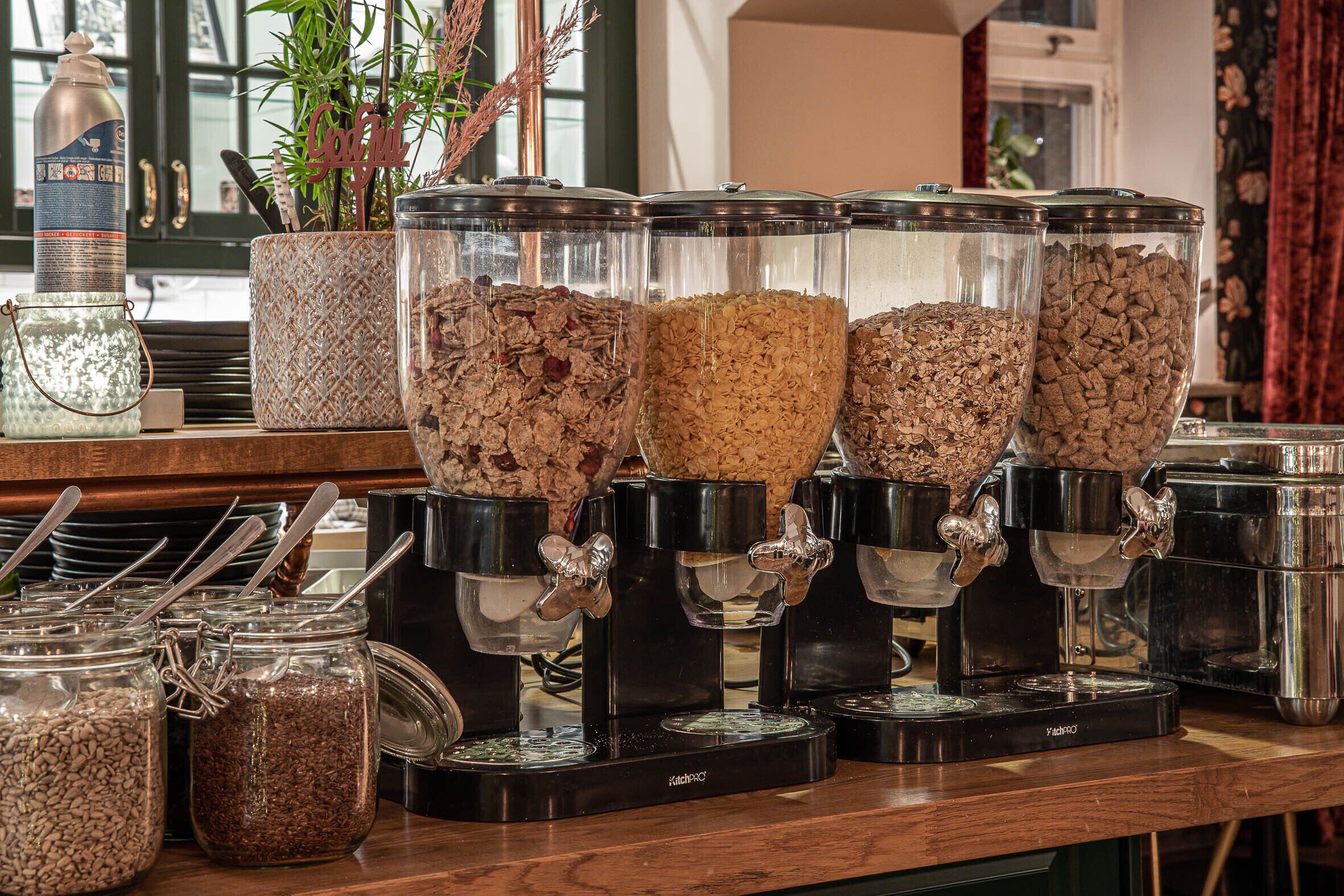 A coffee station with multiple dispensers and jars of coffee beans.