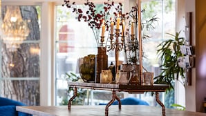 A wooden table with a candle holder and decorative items. - Hotell Arkad (Vasteras)