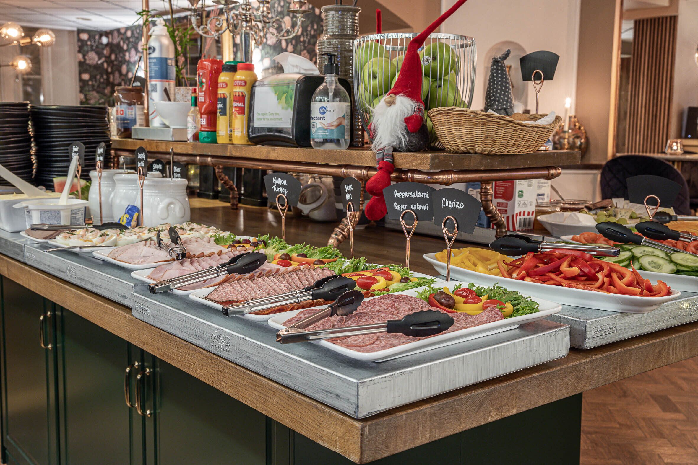 A buffet with various food options, including meats, salads, and vegetables.