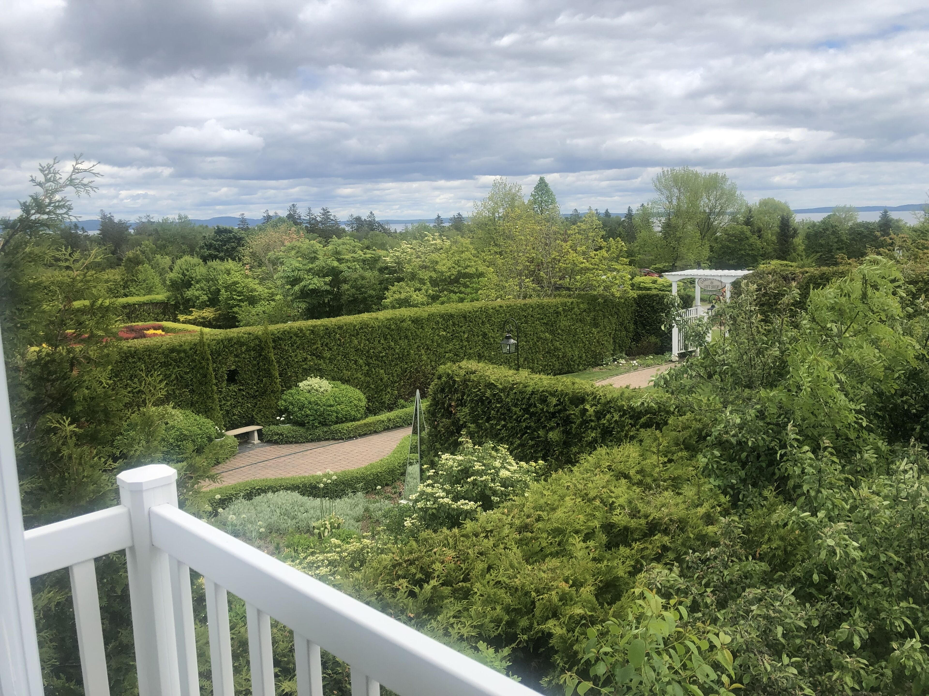 A lush garden with neatly trimmed hedges and a pathway.