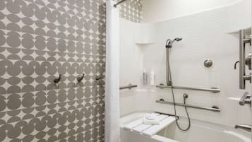 A modern bathroom with a shower, a bathtub, and a towel rack.