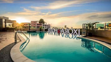 Outdoor pool, open 7:00 AM to 9:00 PM, pool loungers