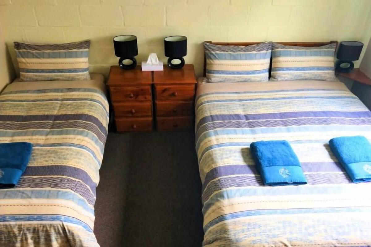 Desk, blackout drapes, iron/ironing board, bed sheets