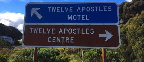 A directional sign for Twelve Apostles Motel and Twelve Apostles Centre.