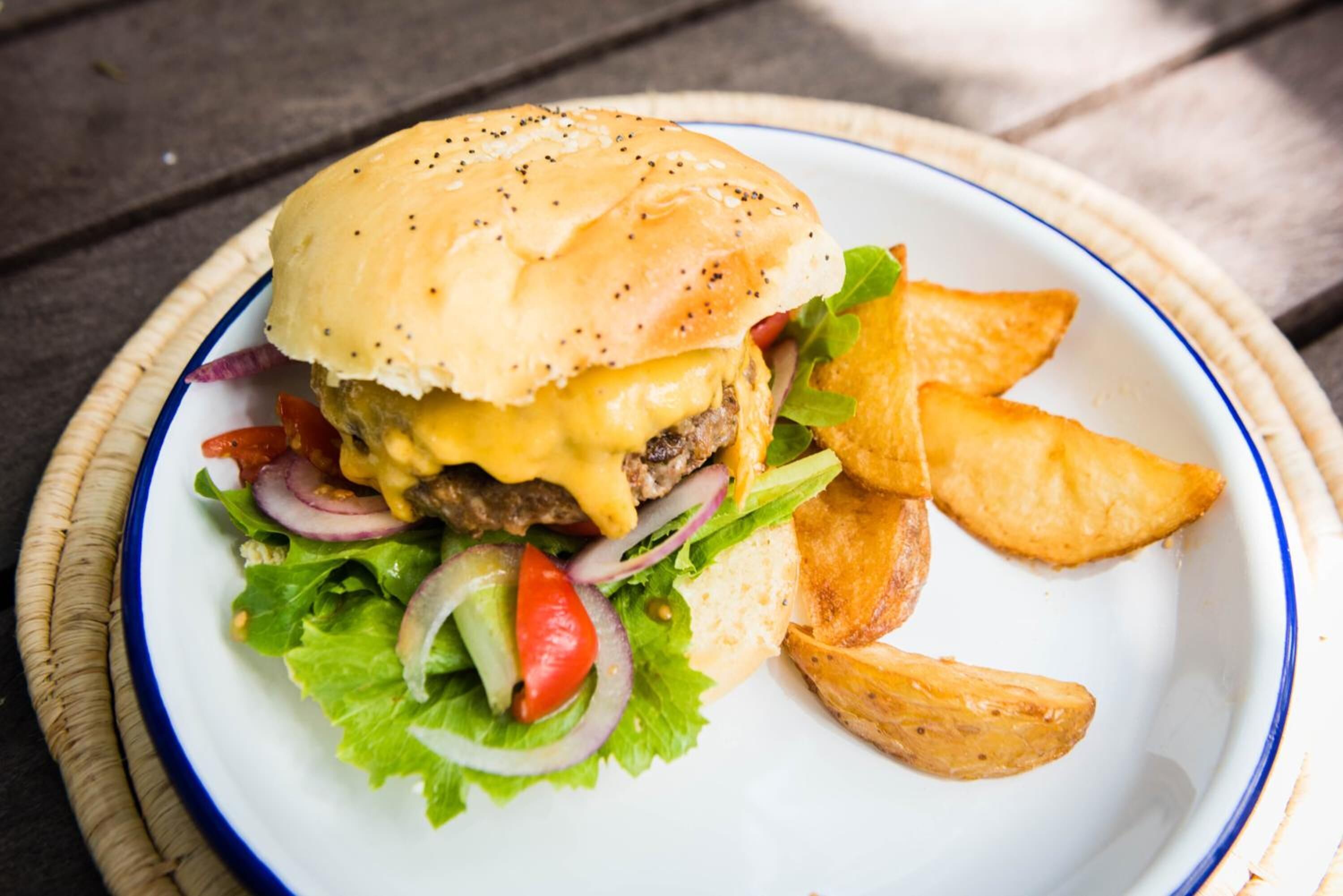 A plate with a burger, fries, and salad.