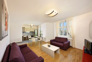 Deluxe Apartment, 3 Bedrooms, Terrace | Living room | Flat-screen TV