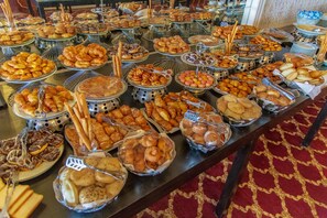 A buffet table with various baked goods and pastries. - Windsor Palace Luxury Heritage Hotel Since 1906 by Paradise Inn Group (Alexandria)